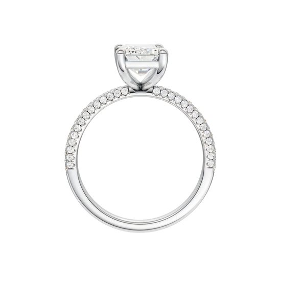 A profile view of the Emerald cut diamond engagement ring in 14k white gold with a pavé diamond band and cathedral setting