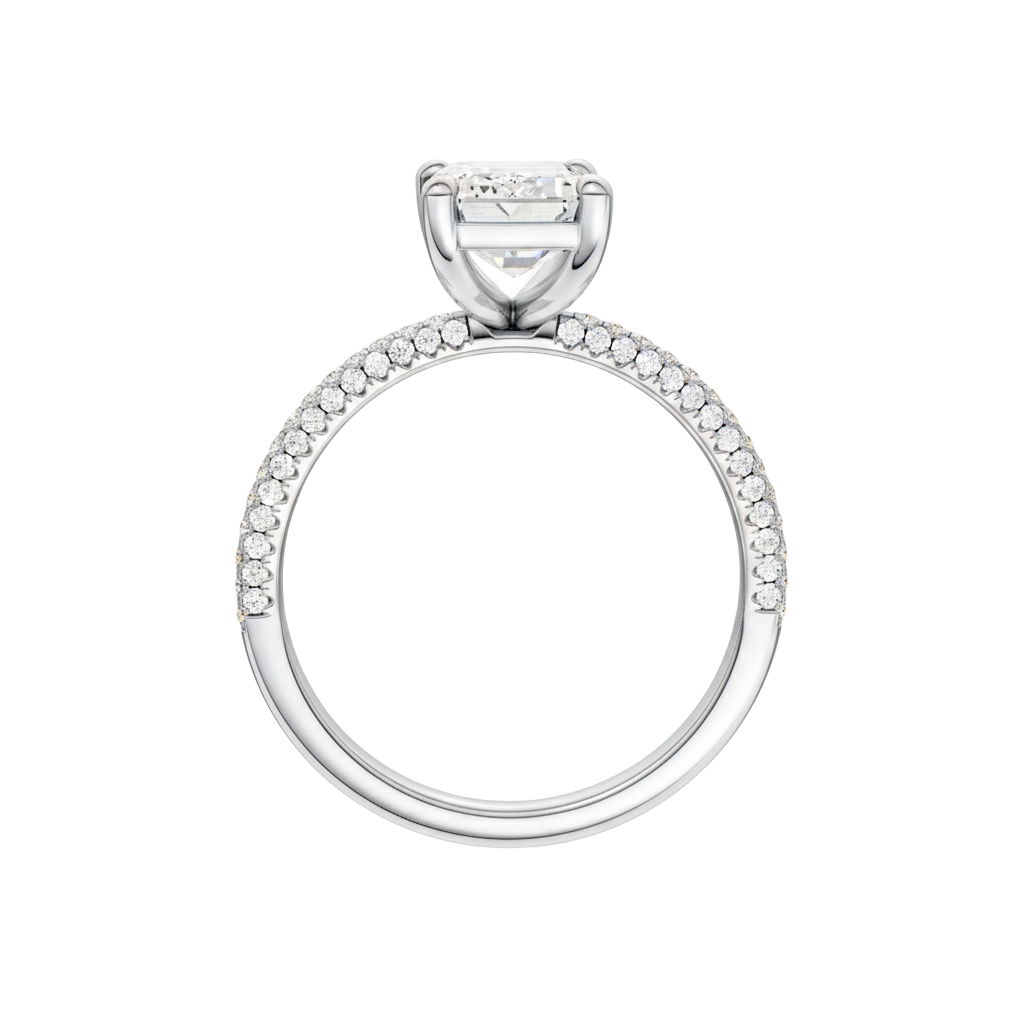 A profile view of the Emerald cut diamond engagement ring in 14k white gold with a pavé diamond band and cathedral setting