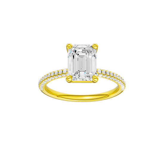 A front view of the Emerald cut diamond engagement ring in 14k yellow gold with a pavé diamond band and cathedral setting