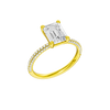 A three-quarter view of the Emerald cut diamond engagement ring in 14k yellow gold with a pavé diamond band and cathedral setting