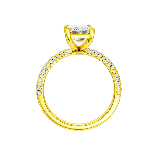 A profile view of the Emerald cut diamond engagement ring in 14k yellow gold with a pavé diamond band and cathedral setting