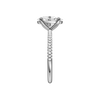 A side view of the oval cut diamond engagement ring in platinum with a pavé diamond band and cathedral setting