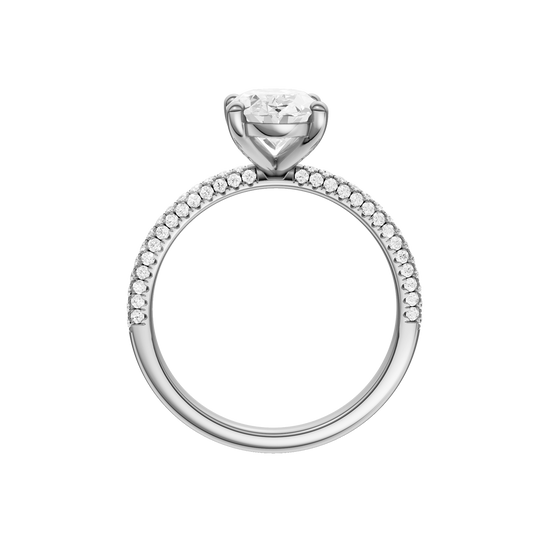 A profile view of the oval cut diamond engagement ring in 14k white gold with a pavé diamond band and cathedral setting