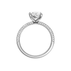 A profile view of the oval cut diamond engagement ring in platinum with a pavé diamond band and cathedral setting