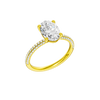 A three-quarter view of the oval cut diamond engagement ring in 14k yellow gold with a pavé diamond band and cathedral setting