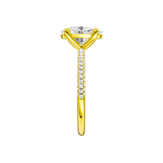 A side view of the oval cut diamond engagement ring in 14k yellow gold with a pavé diamond band and cathedral setting