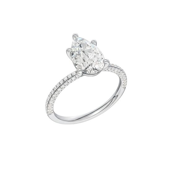 A three-quarter view of the Pear cut diamond engagement ring in 14k white gold with a pavé diamond band and cathedral setting
