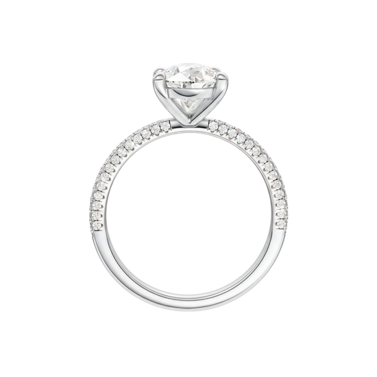 A profile view of the Pear cut diamond engagement ring in 14k white gold with a pavé diamond band and cathedral setting