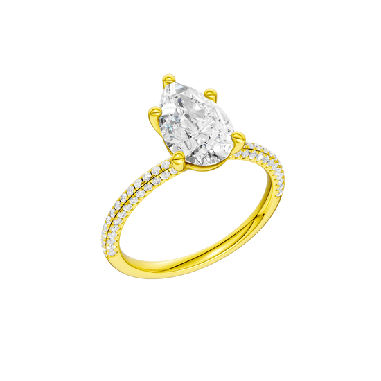 A three-quarter view of the Pear cut diamond engagement ring in 14k yellow gold with a pavé diamond band and cathedral setting
