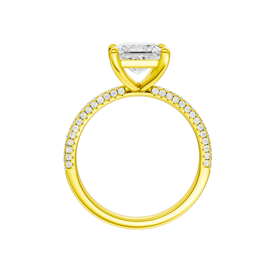 A profile view of the Princess cut diamond engagement ring in 14k yellow gold with a pavé diamond band and cathedral setting