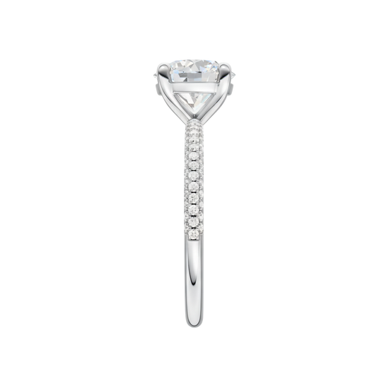 A side view of the Round cut diamond engagement ring in 14k white gold with a pavé diamond band and cathedral setting