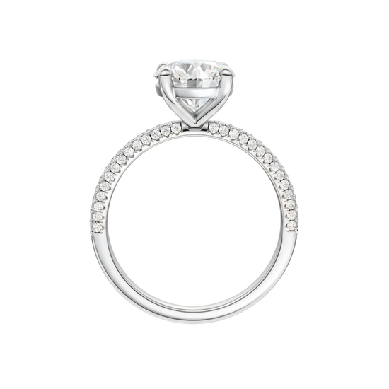 A profile view of the Round cut diamond engagement ring in 14k white gold with a pavé diamond band and cathedral setting