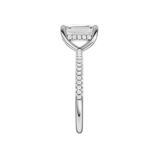 A side view of the Emerald cut diamond engagement ring in 14k white gold with a pavé diamond band and cathedral setting