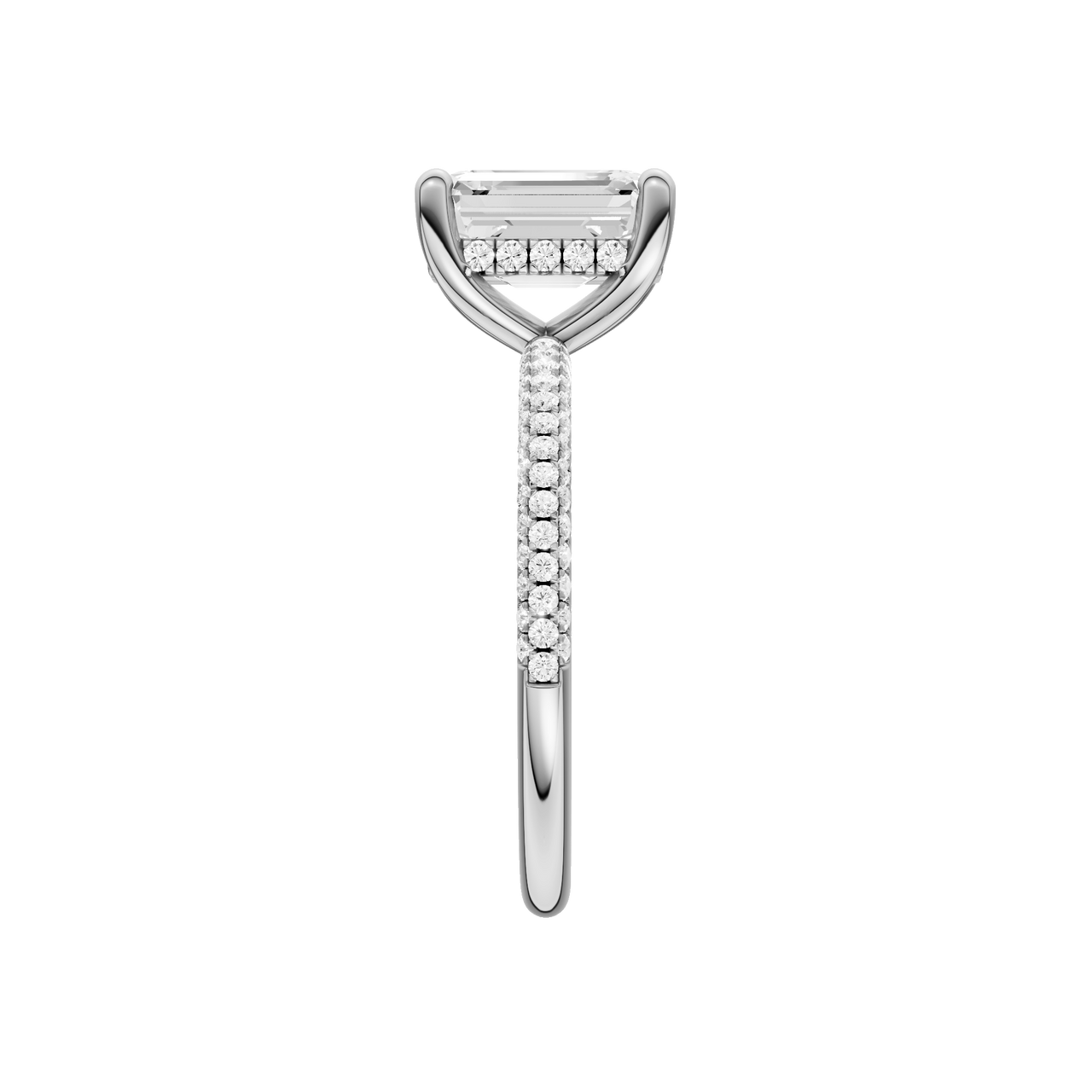 A side view of the Emerald cut diamond engagement ring in 14k white gold with a pavé diamond band and cathedral setting