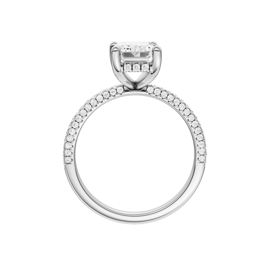 A profile view of the Emerald cut diamond engagement ring in platinum with a pavé diamond band and cathedral setting