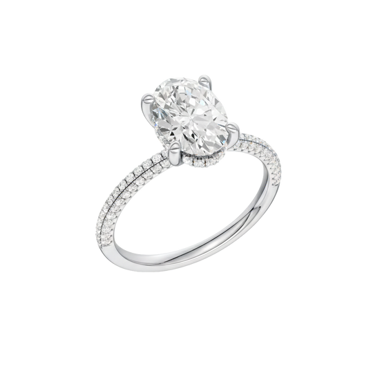 A three-quarter view of the Oval cut diamond engagement ring in 14k white gold with a pavé diamond band and cathedral setting