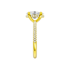 A side view of the Oval cut diamond engagement ring in 14k yellow gold with a pavé diamond band and cathedral setting