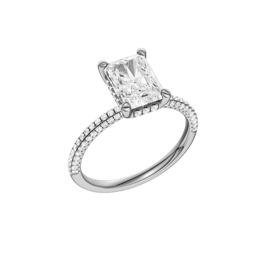 A three-quarter view of the Radiant cut diamond engagement ring in platinum with a pavé diamond band and cathedral setting