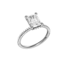 A three-quarter view of the Radiant cut diamond engagement ring in platinum with a pavé diamond band and cathedral setting