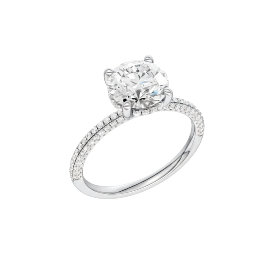 A three-quarter view of the Round cut diamond engagement ring in 14k white gold with a pavé diamond band and cathedral setting