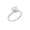 A three-quarter view of the Round cut diamond engagement ring in 14k white gold with a pavé diamond band and cathedral setting