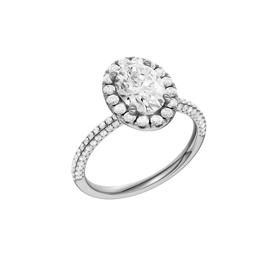 A three-quarter view of the oval cut diamond engagement ring in 14k white gold with a pavé diamond band and solitaire setting