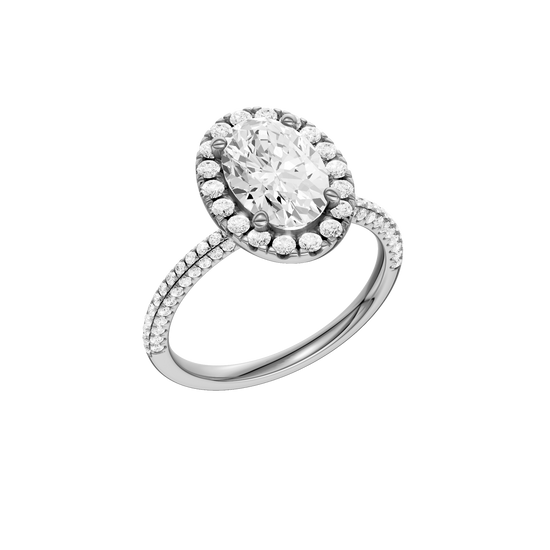 A three-quarter view of the oval cut diamond engagement ring in platinum with a pavé diamond band and solitaire setting