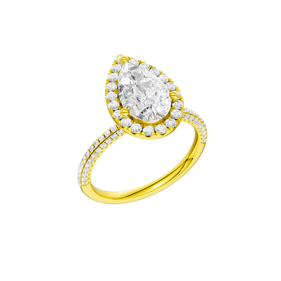 A three-quarter view of the Pear cut diamond engagement ring in 14k yellow gold with a pavé diamond band and solitaire setting