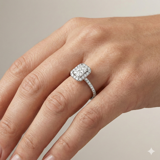 Radiant cut diamond engagement ring in 14k white gold with a pavé diamond band and solitaire setting on a hand