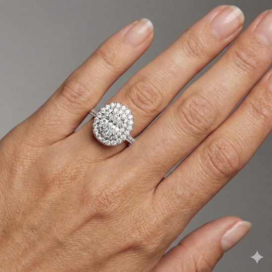 Elongated cushion cut diamond engagement ring in 14k white gold with a pavé diamond band and solitaire setting on a hand
