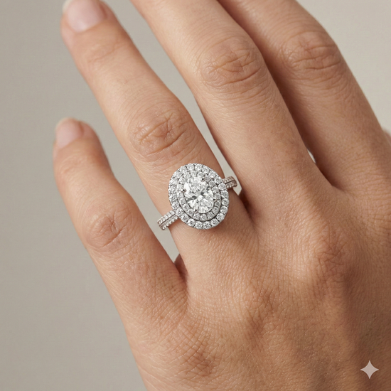 Oval cut diamond engagement ring in 14k white gold with a pavé diamond band and solitaire setting on a hand