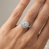 Round cut diamond engagement ring in 14k white gold with a pavé diamond band and solitaire setting on a hand