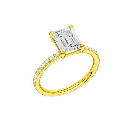 A three-quarter view of the Emerald cut diamond engagement ring in 14k yellow gold with a prong diamond band and cathedral setting