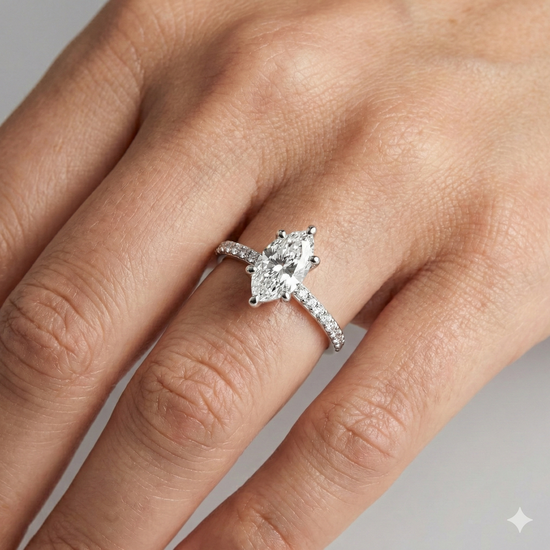 Marquise cut diamond engagement ring in 14k white gold with a prong diamond band and cathedral setting on a hand