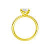 A profile view of the Oval cut diamond engagement ring in 14k yellow gold with a prong diamond band and cathedral setting