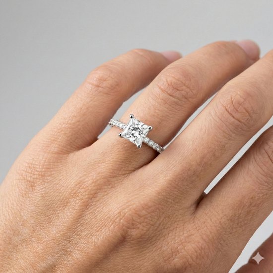 Princess cut diamond engagement ring in 14k white gold with a prong diamond band and cathedral setting on a hand