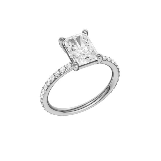 A three-quarter view of the radiant cut diamond engagement ring in platinum with a prong diamond band and cathedral setting