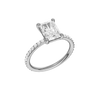 A three-quarter view of the radiant cut diamond engagement ring in platinum with a prong diamond band and cathedral setting