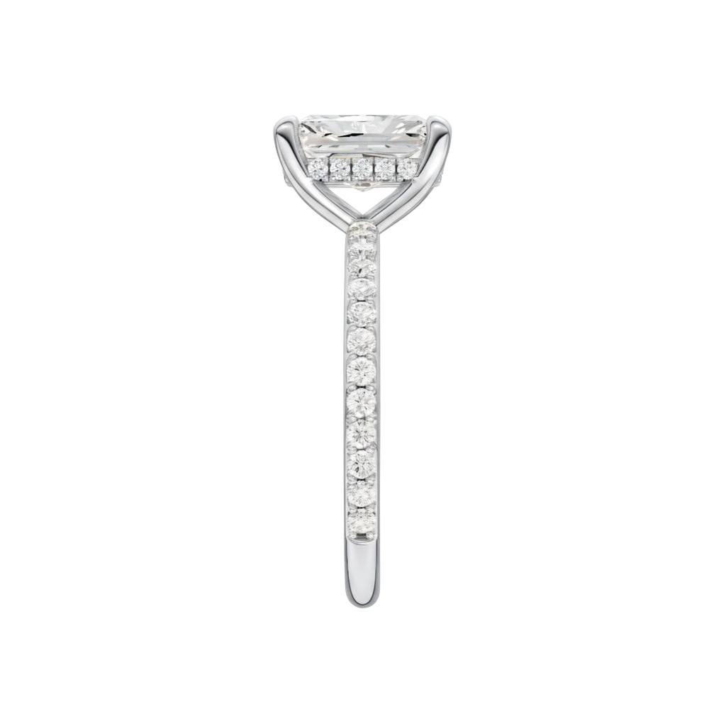A side view of the Radiant cut diamond engagement ring in 14k white gold with a diamond band and hidden halo, cathedral setting