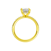 A profile view of the Radiant cut diamond engagement ring in 14k yellow gold with a diamond band and hidden halo, cathedral setting