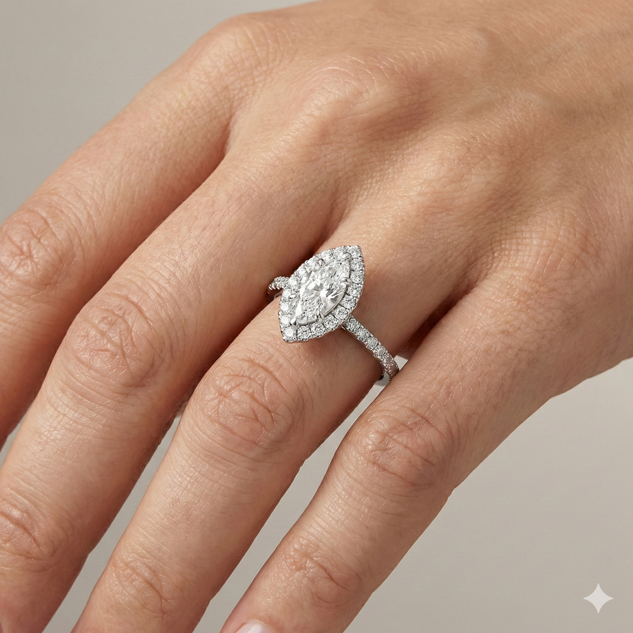 Marquise cut diamond engagement ring in 14k white gold with a prong diamond band and cathedral setting on a hand