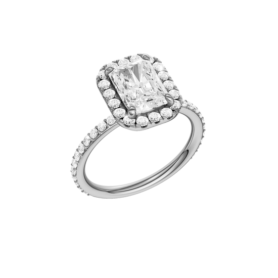 A three-quarter view of the radiant cut diamond engagement ring in platinum with a prong diamond band and cathedral setting