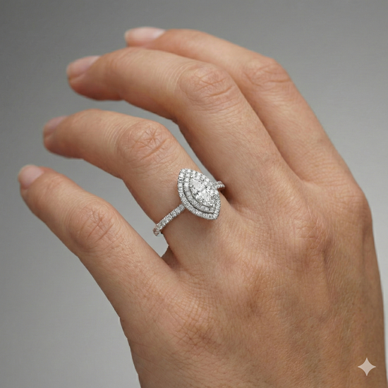 Marquise cut diamond engagement ring in 14k white gold with a prong diamond band and cathedral setting on a hand