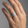 Oval cut diamond engagement ring in 14k white gold with a prong diamond band and cathedral setting on a hand