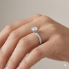 Elongated cushion cut diamond engagement ring in 14k white gold with a diamond channel band and cathedral setting on a hand