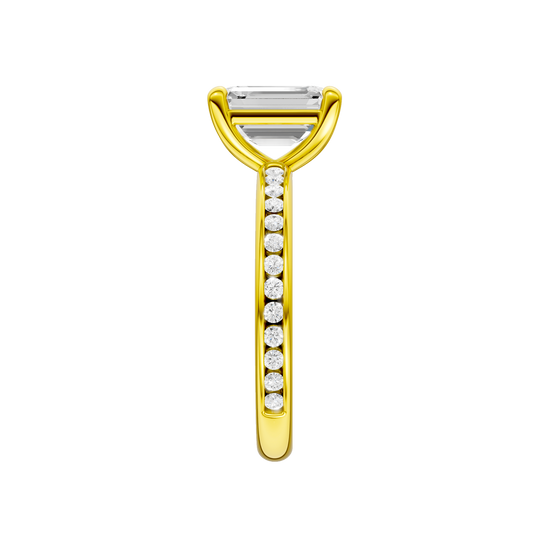 A side view of the Emerald cut diamond engagement ring in 14k yellow gold with a diamond channel band and cathedral setting