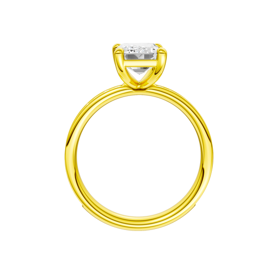 A profile view of the Emerald cut diamond engagement ring in 14k yellow gold with a diamond channel band and cathedral setting
