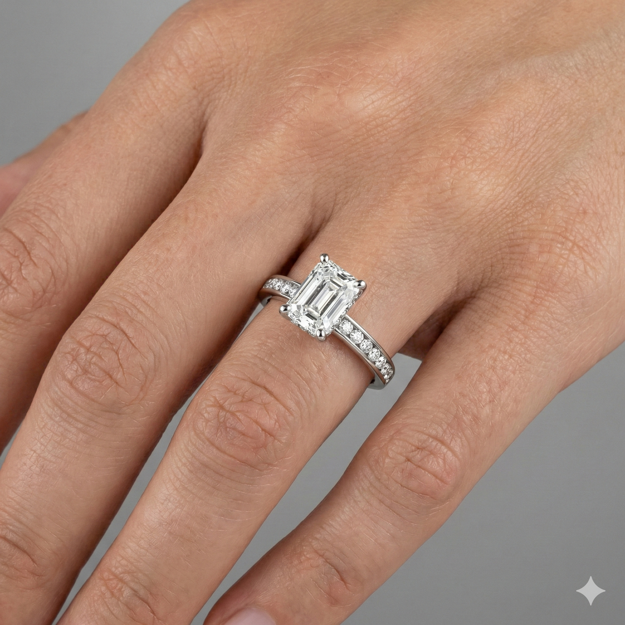 Radiant cut diamond engagement ring in 14k white gold with a diamond channel band and cathedral setting on a hand