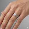 Round cut diamond engagement ring in 14k white gold with a diamond channel band and cathedral setting on a hand