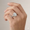 Emerald cut diamond engagement ring in 14k white gold with a diamond channel band and cathedral setting on a hand